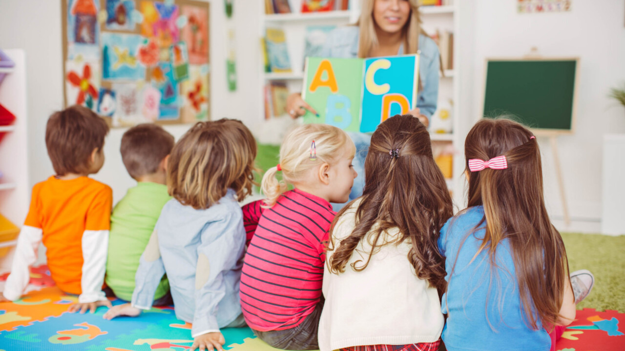 Teacher with a group of preschool children in a nursery.